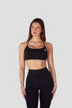 Detalle del conjunto VORE Essence negro: cintura alta del legging y bajo del top