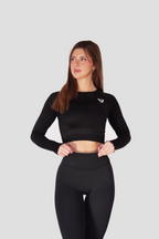 Conjunto VORE Essence negro con top de manga larga y leggins, vista de espalda